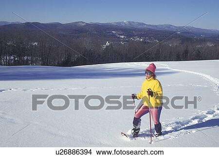 Picture -  snowshoeing, winter, Vermont, Montpelier, VT, Woman snowshoeing in winter.. Fotosearch