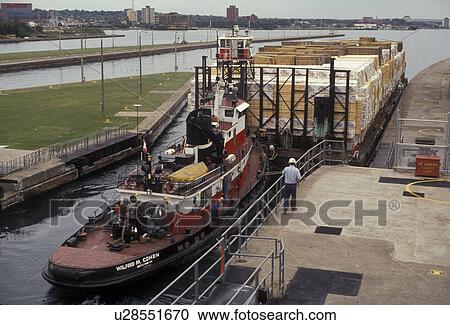 Soo Locks, lock, Upper Peninsula, U. P Michigan, Lake Superior, Sault Ste. Marie, A tugboat pushes a barge out of the lock at Soo Locks in Sault Sainte Marie in the state of Michigan. View Large Photo Image Stock Image - Soo Locks, lock, Upper Peninsula, U. P Michigan, Lake Superior, Sault Ste. Marie, A tugboat pushes a barge out of the lock at Soo Locks in Sault Sainte Marie in the state of Michigan.. Fotosearch