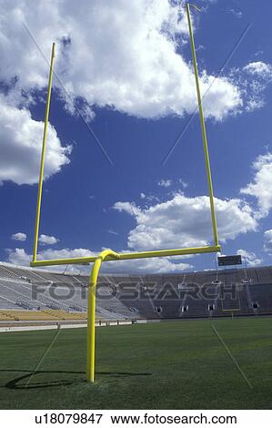 Stock Photo -  South Bend, Notre Dame University, football, Indiana, A yellow gold post stands upright at the end zone of the huge football stadium at the University of Notre Dame in South Bend.. Fotosearch