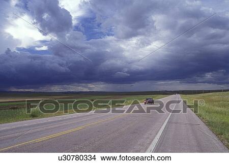 South Dakota, Car driving down isolated highway 385 as storm clouds form above in Fall River County in Oelrichs View Large Photo Image Picture - South Dakota, Car driving down isolated highway 385 as storm clouds form above in Fall River County in Oelrichs. Fotosearch
