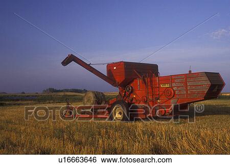 South Dakota, Farm machinery baling hay in field in Day County. View Large Photo Image Stock Photograph - South Dakota, Farm machinery baling hay in field in Day County.. Fotosearch