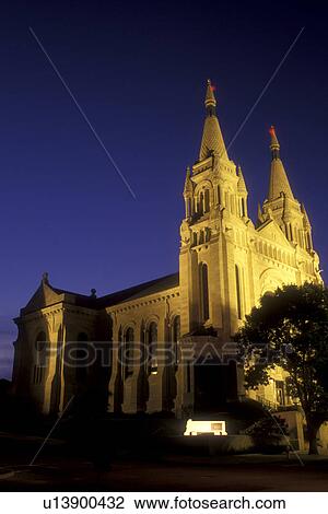 Stock Image -  South Dakota, Saint Joseph's Cathedral is illuminated at night in Sioux Falls. French and German Romanesque Architecture.. Fotosearch