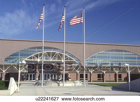 Stock Photo -  South Dakota, U. S. flags fly in front of Sioux Falls Convention Center in Sioux Falls.. Fotosearch