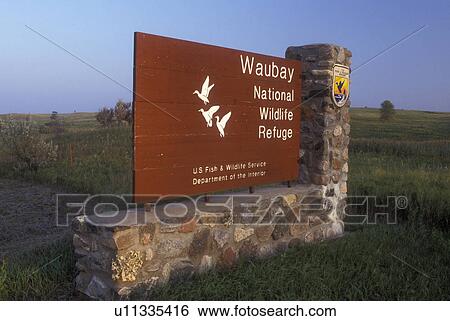 Stock Photograph -  South Dakota, Waubay National Wildlife Refuge entrance sign. Home to many species of birds and mammals.. Fotosearch