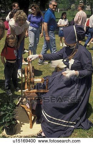 spinning wheel, artisan, antique, demonstration, wool. Georgia. A woman spins yarn from wool on a spinning wheel as people watch at the Dogwood Festival in Piedmont Park in Atlanta, Georgia. View Large Photo Image Stock Image - spinning wheel, artisan, antique, demonstration, wool. Georgia. A woman spins yarn from wool on a spinning wheel as people watch at the Dogwood Festival in Piedmont Park in Atlanta, Georgia. . Fotosearch