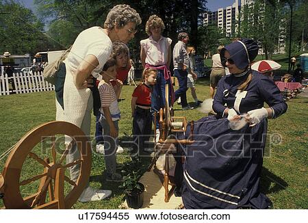 spinning wheel, artisan, antique, demonstration, wool. Georgia. A woman spins yarn from wool on a spinning wheel as people watch at the Dogwood Festival in Piedmont Park in Atlanta, Georgia. View Large Photo Image Stock Photography - spinning wheel, artisan, antique, demonstration, wool. Georgia. A woman spins yarn from wool on a spinning wheel as people watch at the Dogwood Festival in Piedmont Park in Atlanta, Georgia. . Fotosearch