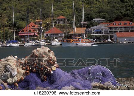 St. Barthelemy, Caribbean, Gustavia, St. Barts, Caribbean Islands, Saint Barts, Fishing nets in the foreground of the scenic harborfront of Gustavia the capital of the island of Saint Barthelemy (a department of Guadeloupe). View Large Photo Image Stock Photograph - St. Barthelemy, Caribbean, Gustavia, St. Barts, Caribbean Islands, Saint Barts, Fishing nets in the foreground of the scenic harborfront of Gustavia the capital of the island of Saint Barthelemy (a department of Guadeloupe).. Fotosearch