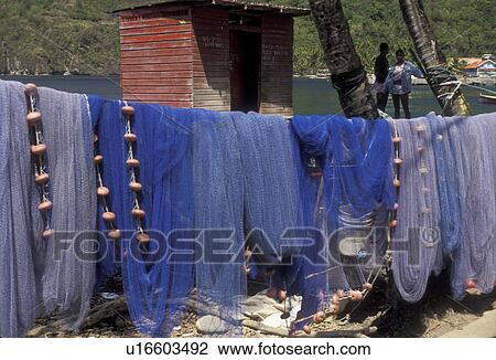 Stock Image -  St. Lucia, Caribbean, fishing nets, Caribbean Islands, Blue fishing nets hang to dry on the beach of Choiseul in the sun on the island of Saint Lucia (a British Commonwealth member).. Fotosearch