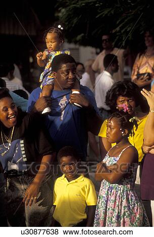St. Martin, Caribbean, carnival, Caribbean Islands, Family of local black people watching a parade during the carnival in Marigot the French capital of the island of Saint Martin (french part). View Large Photo Image Stock Photo - St. Martin, Caribbean, carnival, Caribbean Islands, Family of local black people watching a parade during the carnival in Marigot the French capital of the island of Saint Martin (french part).. Fotosearch