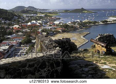 Stock Image -  St. Martin, Caribbean, Marigot, Caribbean Islands, Scenic view of Nettle Bay and Marigot French capital of the island of Saint Martin (french part) from Fort St. Louis. A cannon guards the city.. Fotosearch