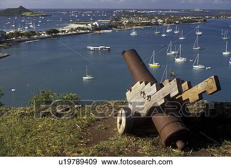 Stock Photo -  St. Martin, Caribbean, Marigot, Caribbean Islands, Scenic view of Nettle Bay from Fort St. Louis in Marigot on the island of Saint Martin (french part). A cannon guards the city.. Fotosearch