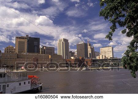 St. Paul, skyline, Twin cities, Mississippi River, Minnesota, A view of the downtown skyline of Saint Paul as a paddle wheel tourboat cruises down the Mississippi River in the state of Minnesota. View Large Photo Image Picture - St. Paul, skyline, Twin cities, Mississippi River, Minnesota, A view of the downtown skyline of Saint Paul as a paddle wheel tourboat cruises down the Mississippi River in the state of Minnesota.. Fotosearch