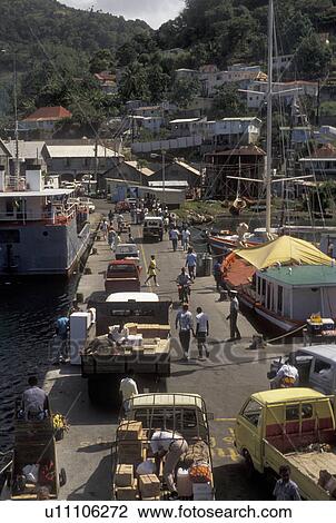 Stock Image -  St. Vincent, Caribbean, Kingstown, Caribbean Islands, People unloading goods from boats on a busy dock in Kingstown on the island of Saint Vincent (a British Commonwealth member).. Fotosearch