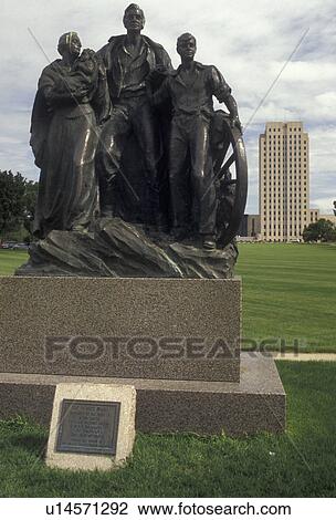 State Capitol, Bismarck, State House, North Dakota, The Pioneer Family statue on the State Capitol Grounds with the State Capitol Building skyscraper of the prairie in the distance in the capital city of Bismarck in the state of North Dakota. View Large Photo Image Stock Image - State Capitol, Bismarck, State House, North Dakota, The Pioneer Family statue on the State Capitol Grounds with the State Capitol Building skyscraper of the prairie in the distance in the capital city of Bismarck in the state of North Dakota.. Fotosearch