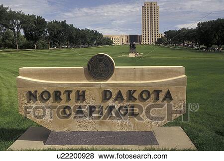 State Capitol, Bismarck, State House, North Dakota, North Dakota State Capitol sign in the foreground with the State Capitol Building skyscraper of the prairie in the distance in the capital city of Bismarck in the state of North Dakota. View Large Photo Image Stock Photo - State Capitol, Bismarck, State House, North Dakota, North Dakota State Capitol sign in the foreground with the State Capitol Building skyscraper of the prairie in the distance in the capital city of Bismarck in the state of North Dakota.. Fotosearch