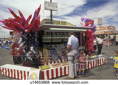 Stock Photo -  state fair, York, Pennsylvania, People at a souvenir booth at the York Fair (America's oldest agricultural fair) in the town of York in the state of Pennsylvania. . Fotosearch