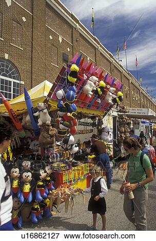Stock Photo -  state fair, York, Pennsylvania, Young girl chooses a toy at a souvenir booth at the York Fair (America's oldest agricultural fair) in the town of York in the state of Pennsylvania. . Fotosearch