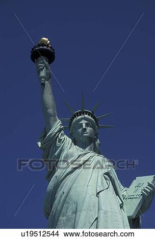 Picture -  Statue of Liberty, New York City, Statue of Liberty National Monument, close-up, N. Y. C New York, NYC, The towering Statue of Liberty Nat'l Monument stands proud against a clear blue sky on Liberty Island on a sunny day in New York City in the state of Ne. Fotosearch