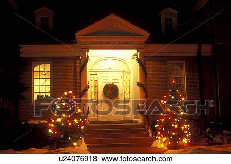 Stock Photo -  Stockbridge, Berkshires, Massachusetts, Christmas lights decorate the entrance to the Stockbridge Library at night in Stockbridge in the state of Massachusetts.. Fotosearch