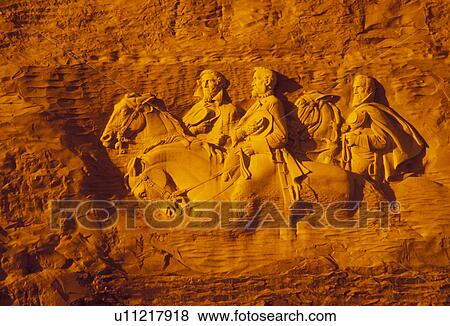 Stock Photo -  Stone Mountain, Stone Mountain Park, Atlanta, Georgia, Golden sunlight shines on The Confederate Memorial Carving of President Jefferson Davis, General Thomas Stonewall Jackson and General Robert E. Lee on Stone Mountain in Georgia's Stone Mountain Park . Fotosearch