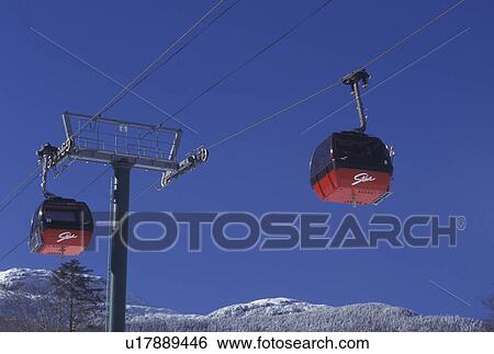 Stock Photograph -  Stowe, gondola, skiing, Vermont, VT, Red Gondolas at Stowe Ski Area at Stowe Mountain Resort in Stowe in the snow in winter.. Fotosearch