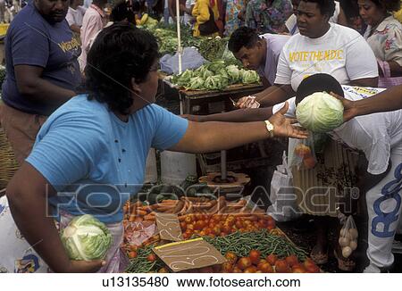 Stock Image -  street market, Trinidad, Trinidad and Tobago, Caribbean, Port of Spain, Caribbean Islands, Local woman selling fresh produce on Market Day in the city of Port of Spain the capital city on the island of Trinidad (a British Commonwealth member).. Fotosearch