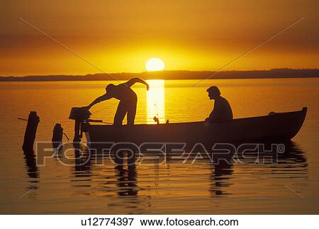 sunrise, sunset, boat, Chile, Two men in a fishing boat silhouetted against the sunrise on Lago Llanquihue in the South-Central Region (the Land of Lakes and Volcanoes) in Chile. View Large Photo Image Stock Photo - sunrise, sunset, boat, Chile, Two men in a fishing boat silhouetted against the sunrise on Lago Llanquihue in the South-Central Region (the Land of Lakes and Volcanoes) in Chile. . Fotosearch