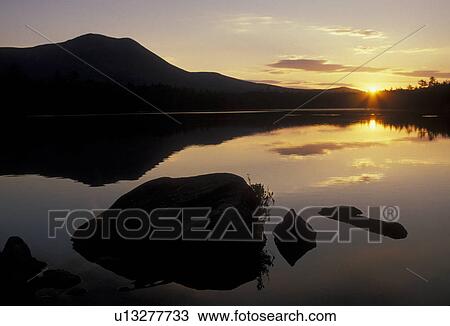 Stock Image -  sunrise, sunset, lake, Maine, Baxter State Park, Scenic sunrise with the reflection of Mt. Katahdin in the calm waters of Daicey Pond in Baxter State Park. . Fotosearch
