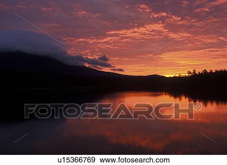 sunrise, sunset, lake, mountain, Maine, Baxter State Park, Sunrise over the calm waters of Daicey Pond. Mt. Katahdin reflects in the water. View Large Photo Image Stock Photo - sunrise, sunset, lake, mountain, Maine, Baxter State Park, Sunrise over the calm waters of Daicey Pond. Mt. Katahdin reflects in the water.. Fotosearch