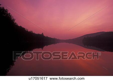 sunset, lake, Vermont, The orange sky reflects in the calm waters of Kettle Pond at sunset in Groton State Forest in Caledonia County in the state of Vermont. View Large Photo Image Stock Photo - sunset, lake, Vermont, The orange sky reflects in the calm waters of Kettle Pond at sunset in Groton State Forest in Caledonia County in the state of Vermont. . Fotosearch