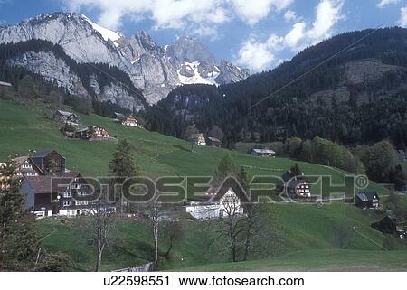 Switzerland, Alps, St. Gallen, Europe, Scenic view of chalets sitting on the high meadows which lead up to the alpine mountains in the Canton of St. Gall in the spring. View Large Photo Image Stock Image - Switzerland, Alps, St. Gallen, Europe, Scenic view of chalets sitting on the high meadows which lead up to the alpine mountains in the Canton of St. Gall in the spring.. Fotosearch