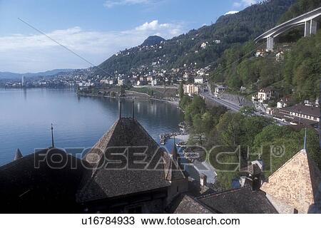 Switzerland, Chillon, Lake Geneva, Montreux, Vaud, Europe, Lac Leman, Scenic view of the waterfront along Lake Geneva and expressway from the Chateau de Chillon a 13th century fortress in the Canton of Vaud. View Large Photo Image Stock Image - Switzerland, Chillon, Lake Geneva, Montreux, Vaud, Europe, Lac Leman, Scenic view of the waterfront along Lake Geneva and expressway from the Chateau de Chillon a 13th century fortress in the Canton of Vaud. . Fotosearch