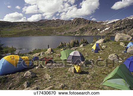 Stock Image -  tent, camping, Bighorn Mountains, Bighorn National Forest, Wyoming, backpacking, Tents set up to camp for the night next to Lake Mistymoon in the Cloud Peak Wilderness Area in Bighorn National Forest in the state of Wyoming. . Fotosearch