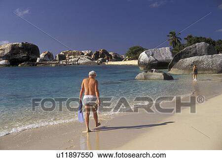 The Baths, Virgin Gorda, beach, British Virgin Islands, Caribbean, Virgin Islands, BVI, B. V. I Man walking on the white sand beach at Spring Bay on the island of Virgin Gorda on the British Virgin Islands. View Large Photo Image Stock Image - The Baths, Virgin Gorda, beach, British Virgin Islands, Caribbean, Virgin Islands, BVI, B. V. I Man walking on the white sand beach at Spring Bay on the island of Virgin Gorda on the British Virgin Islands.. Fotosearch