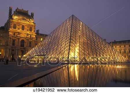 Stock Image -  The Louvre, Musee du Louvre, Paris, France, Europe, The innovative glass pyramid marks the entrance to the famous Musee du Louvre (Louvre Museum) in Paris in the [evening, night]. . Fotosearch