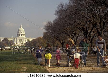 The Mall, Washington, District of Columbia, D. C People walk with their children on the Mall lined with trees with the U. S. Capitol Building in the background in the nations capital Washington, DC. View Large Photo Image Stock Photo - The Mall, Washington, District of Columbia, D. C People walk with their children on the Mall lined with trees with the U. S. Capitol Building in the background in the nations capital Washington, DC.. Fotosearch