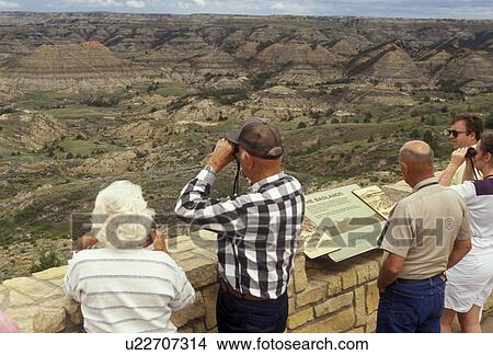 Theodore Roosevelt National Park, South Unit, North Dakota, overlook, tourist, People looking at the view of the badlands from the overlook at the Painted Canyon Visitors Center at Theodore Roosevelt National Park in the South Unit in the state of North View Large Photo Image Picture - Theodore Roosevelt National Park, South Unit, North Dakota, overlook, tourist, People looking at the view of the badlands from the overlook at the Painted Canyon Visitors Center at Theodore Roosevelt National Park in the South Unit in the state of North . Fotosearch