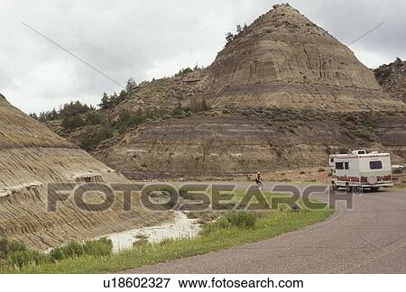 Theodore Roosevelt National Park, RV, South Unit, North Dakota, vacation, travel, road, rock formation, A recreational vehicle travels along the scenic loop drive as it winds through colored rock formations of Theodore Roosevelt National Park in the Sout View Large Photo Image Stock Photo - Theodore Roosevelt National Park, RV, South Unit, North Dakota, vacation, travel, road, rock formation, A recreational vehicle travels along the scenic loop drive as it winds through colored rock formations of Theodore Roosevelt National Park in the Sout. Fotosearch