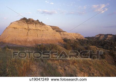 Stock Photo -  Theodore Roosevelt National Park, North Dakota, The late day sun shines on the rock formations at Theodore Roosevelt National Park, South Unit.. Fotosearch