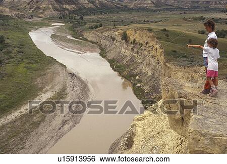 Theodore Roosevelt National Park, North Dakota, Little Missouri River, South Unit, river, hiking, Mother and daughter (6 years old) stand on an overlook rock formation looking out over the Little Missouri River as it carves its way through Theodore Roose View Large Photo Image Stock Photograph - Theodore Roosevelt National Park, North Dakota, Little Missouri River, South Unit, river, hiking, Mother and daughter (6 years old) stand on an overlook rock formation looking out over the Little Missouri River as it carves its way through Theodore Roose. Fotosearch