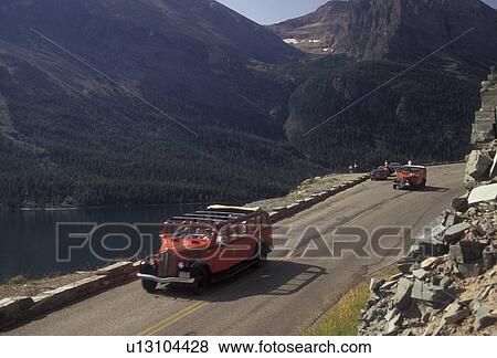 tour bus, Glacier National Park, Montana, Waterton-Glacier International Peace Park, Rocky Mountains, Red tour buses carry tourists up the Going-to-the-Sun road through the picturesque Glacier National Park in the state of Montana. View Large Photo Image Stock Photo - tour bus, Glacier National Park, Montana, Waterton-Glacier International Peace Park, Rocky Mountains, Red tour buses carry tourists up the Going-to-the-Sun road through the picturesque Glacier National Park in the state of Montana.. Fotosearch