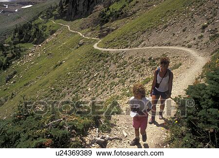 Stock Photo -  trail, mother & daughter, hiking, Glacier National Park, Montana, Rocky Mountains, Waterton-Glacier International Peace Park, Mother and 6 year old daughter hike the Grinnell Lake Trail in scenic Glacier National Park in the state of Montana.. Fotosearch
