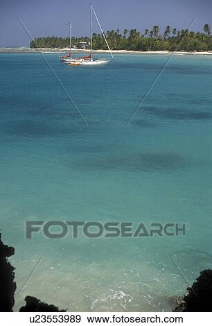 Trinidad and Tobago, Caribbean, Caribbean Islands, Scenic view of sailboat anchored in the calm blue green waters of the Caribbean Sea on Sandy Bay at Pigeon Point on the island of Tobago (a British Commonwealth member). View Large Photo Image Stock Photo - Trinidad and Tobago, Caribbean, Caribbean Islands, Scenic view of sailboat anchored in the calm blue green waters of the Caribbean Sea on Sandy Bay at Pigeon Point on the island of Tobago (a British Commonwealth member).. Fotosearch