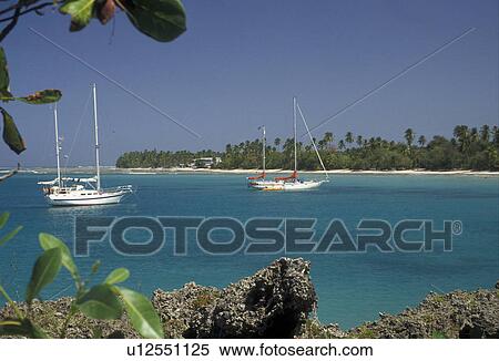 Stock Photography -  Trinidad and Tobago, Caribbean, Caribbean Islands, Scenic view of sailboats anchored in the calm blue green waters of the Caribbean Sea on Sandy Bay at Pigeon Point on the island of Tobago (a British Commonwealth member).. Fotosearch