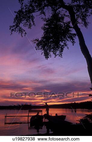 Upper Peninsula, lake, U. P sunrise, sunset, Michigan, Silhouette of fishermen down by the dock at sunset over the calm waters of Ruth Lake in Three Lakes in the state of Michigan. View Large Photo Image Stock Photo - Upper Peninsula, lake, U. P sunrise, sunset, Michigan, Silhouette of fishermen down by the dock at sunset over the calm waters of Ruth Lake in Three Lakes in the state of Michigan.. Fotosearch