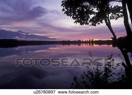 Upper Peninsula, lake, U. P sunrise, sunset, Michigan, Scenic view of the sunset over the calm waters of Beaufort Lake in Three Lakes in the state of Michigan. View Large Photo Image Stock Photo - Upper Peninsula, lake, U. P sunrise, sunset, Michigan, Scenic view of the sunset over the calm waters of Beaufort Lake in Three Lakes in the state of Michigan.. Fotosearch