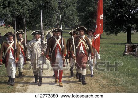 Stock Image -  Valley Forge Park, reenactment, soldiers, Valley Forge, Pennsylvania, Men dressed in Continental Army soldier costumes march together in formation at the reenactment of the American Revolution at the March out of the Continental Army in Valley Forge Nati. Fotosearch