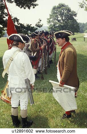 Stock Image -  Valley Forge Park, reenactment, soldiers, Valley Forge, Pennsylvania, A group of men dressed in Continental Army soldier costumes reenact the American Revolution at the March out of the Continental Army in Valley Forge National Historical Park in Valley . Fotosearch