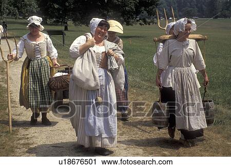 Stock Image -  Valley Forge Park, reenactment, Valley Forge, Pennsylvania, Women dressed in traditional colonial costumes walk together at the reenactment of the American Revolution at the March out of the Continental Army in Valley Forge National Historical Park in Va. Fotosearch