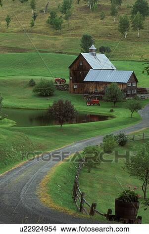 Picture -  Vermont, barn, Red tractors displayed next to barn at scenic Sleepy Hollow Farm in Pomfret . Fotosearch